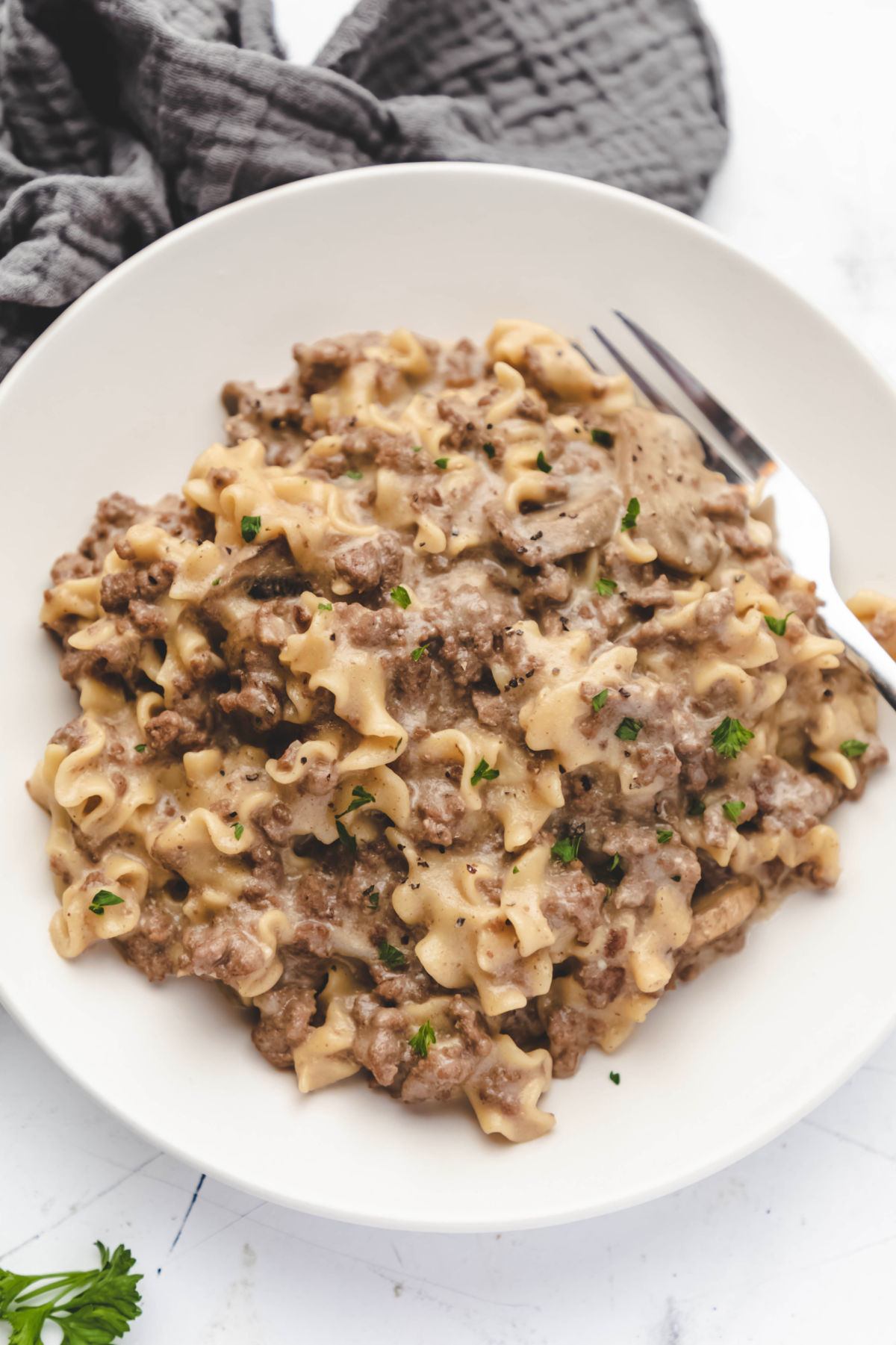 White plate with Instant Pot ground beef stroganoff on it. 