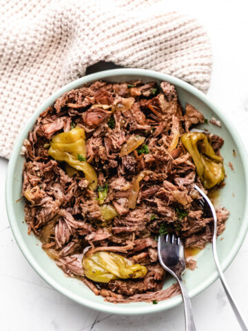 Two forks in a dish of Instant Pot Mississippi pot roast.