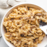 A fork holding a bite of instant pot cheeseburger macaroni.
