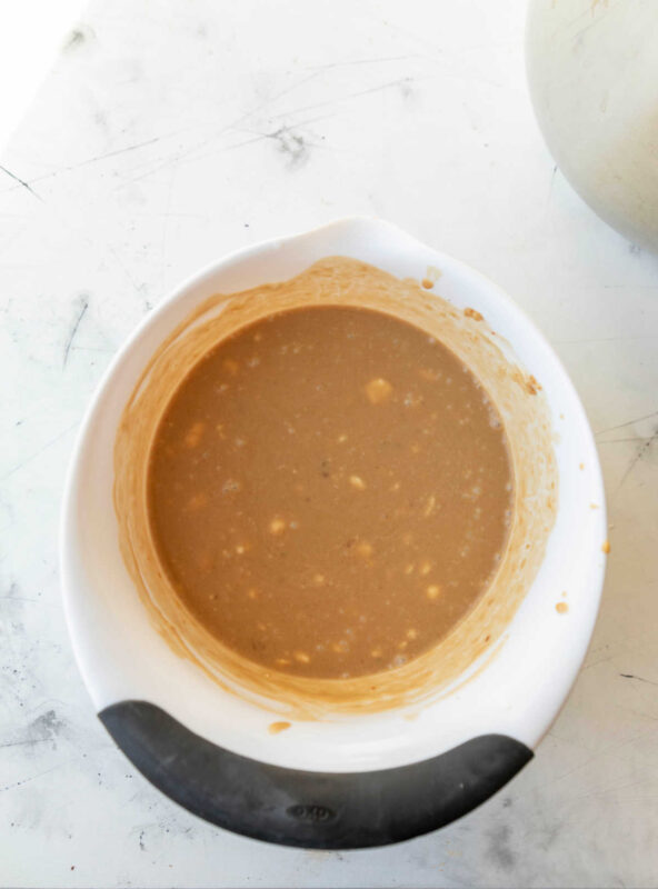 Peanut sauce in a white mixing bowl. 