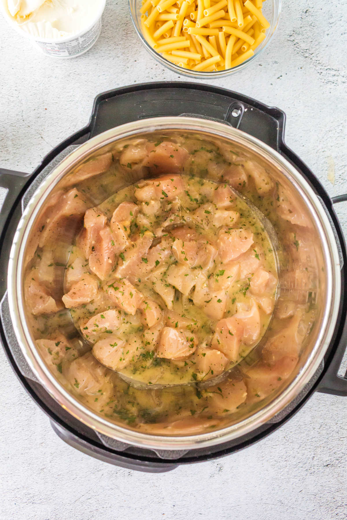 Chicken pieces in dressing in an Instant Pot. 