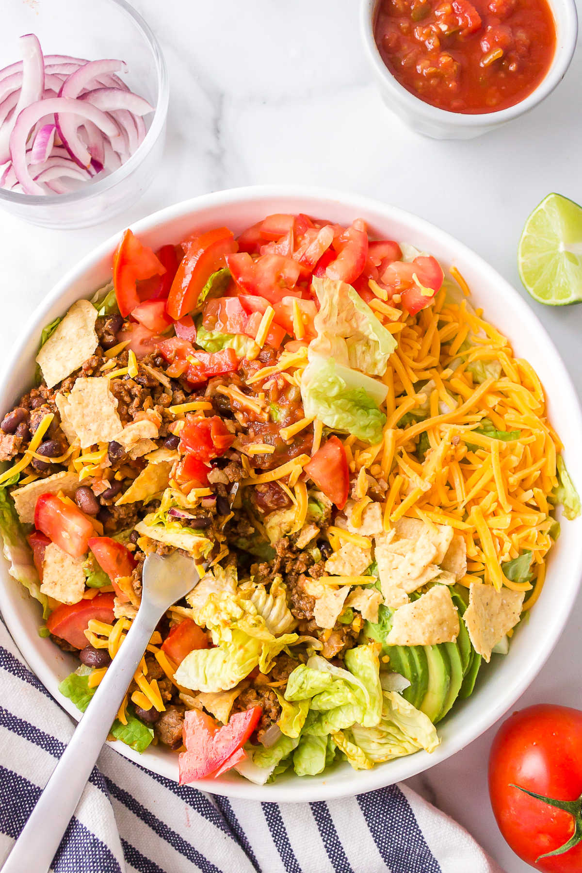 Taco salad with a fork taking a bite. 