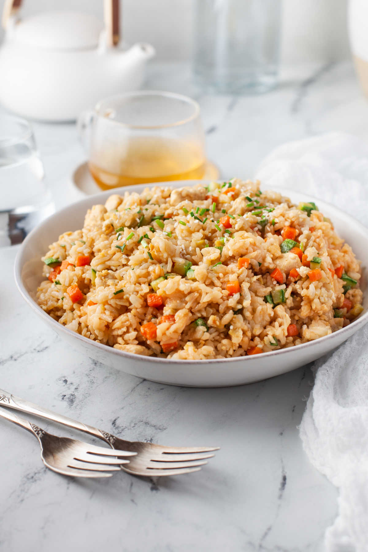 A dish of Instant Pot fried rice next to two silver forks. 