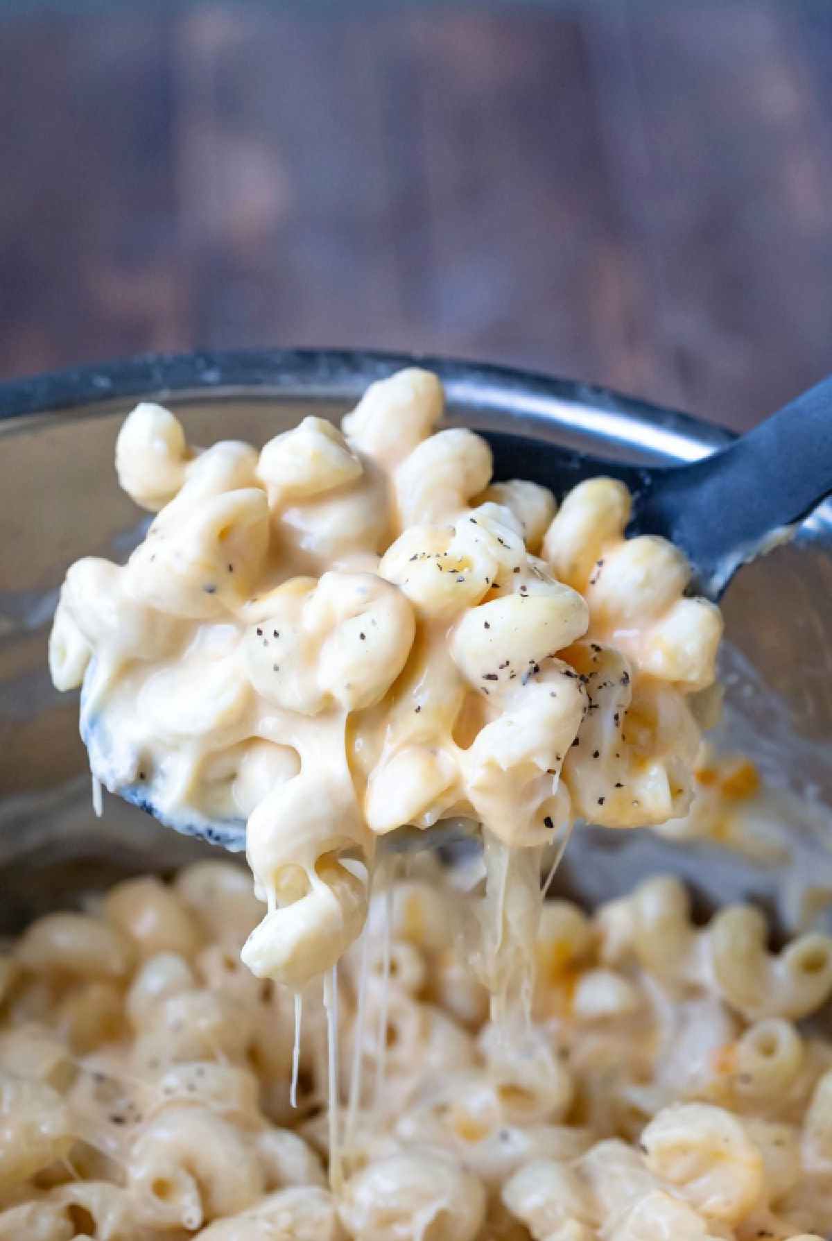 Spoon lifting up a scoop of Instant Pot Mac and Cheese.