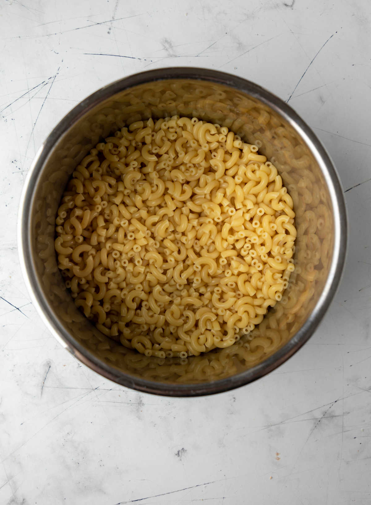 Cooked elbow macaroni in an instant pot inner pot.