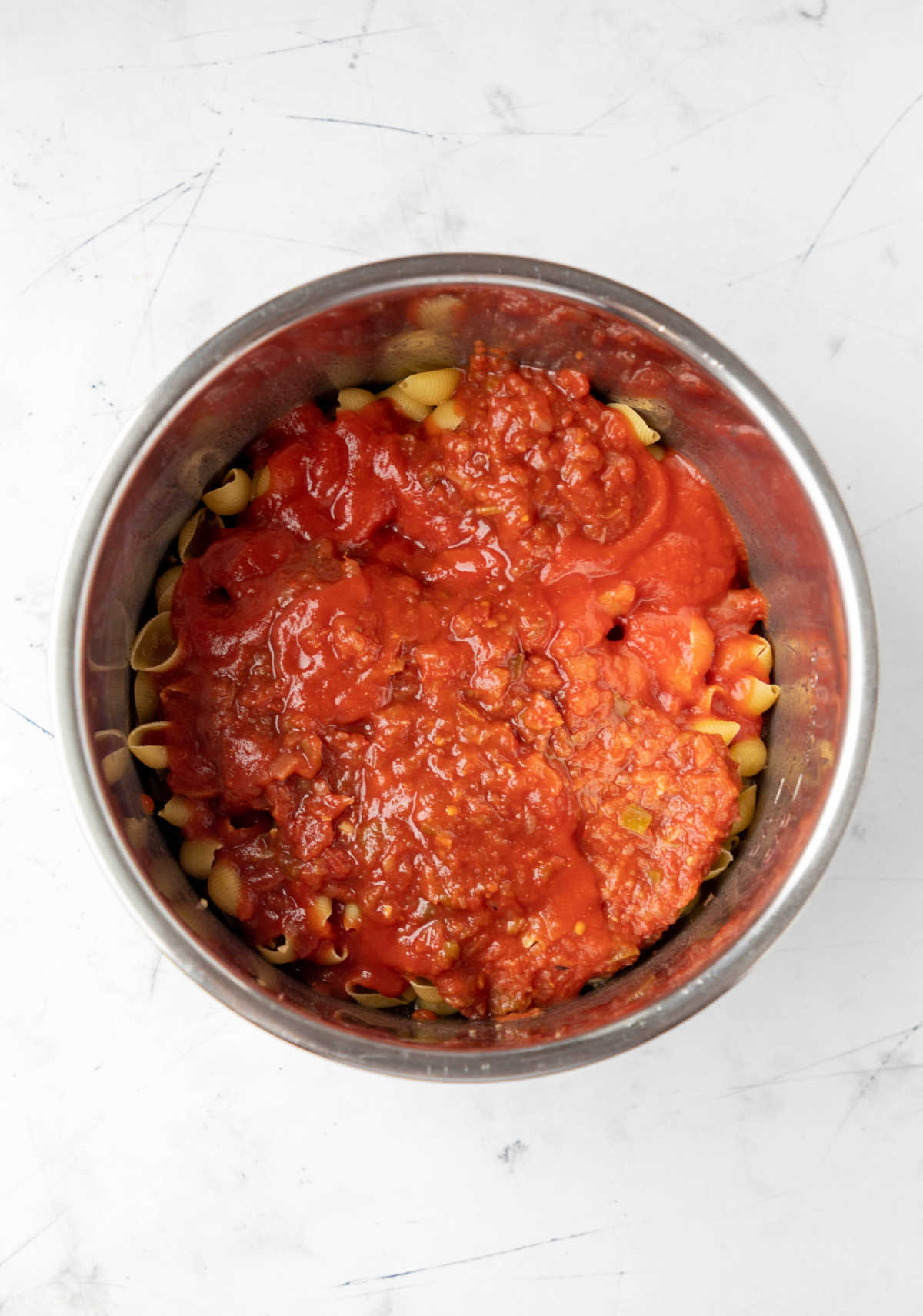 Tomato sauce and salsa on top of pasta in an instant pot. 