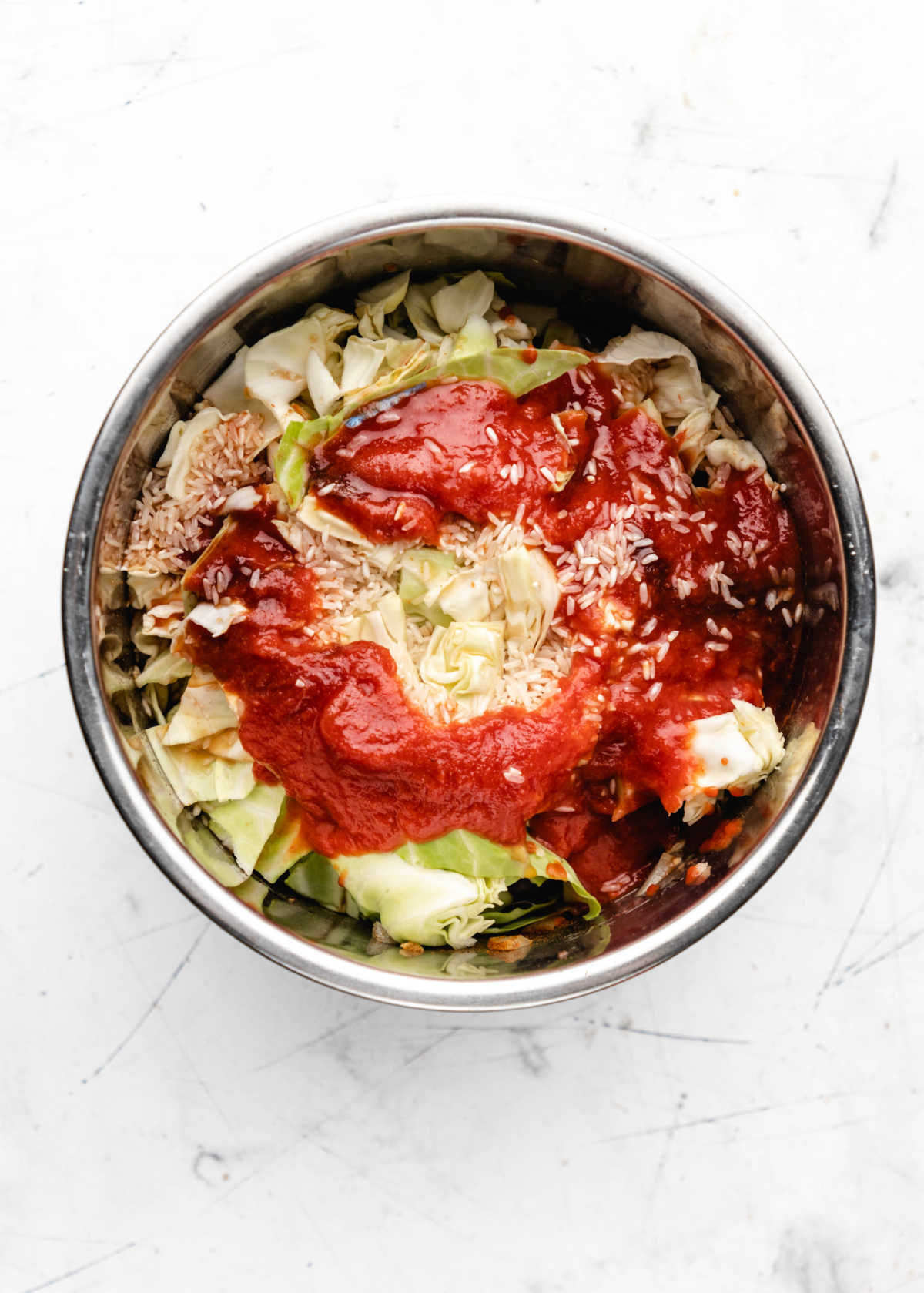Rice over tomato sauce and cabbage in an instant pot. 