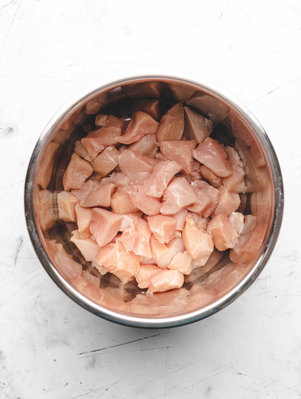 Diced raw chicken in an Instant Pot. 