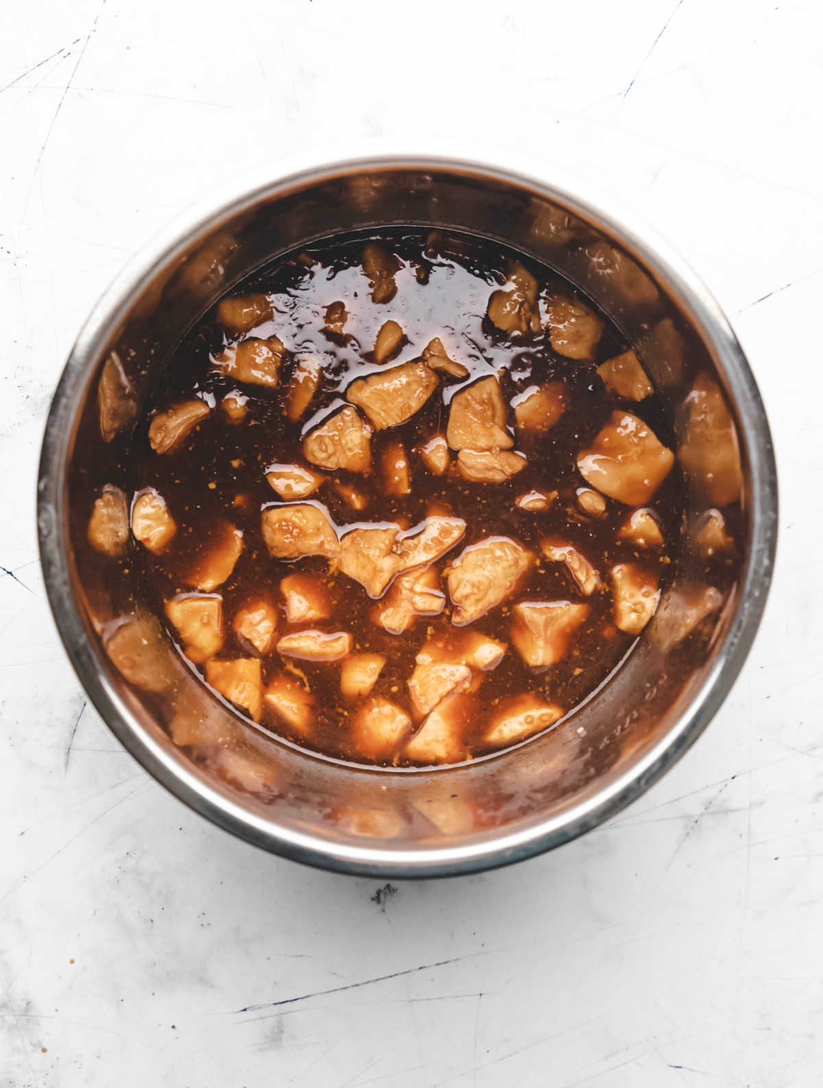 Soy sauce mixture over diced chicken in an Instant Pot. 