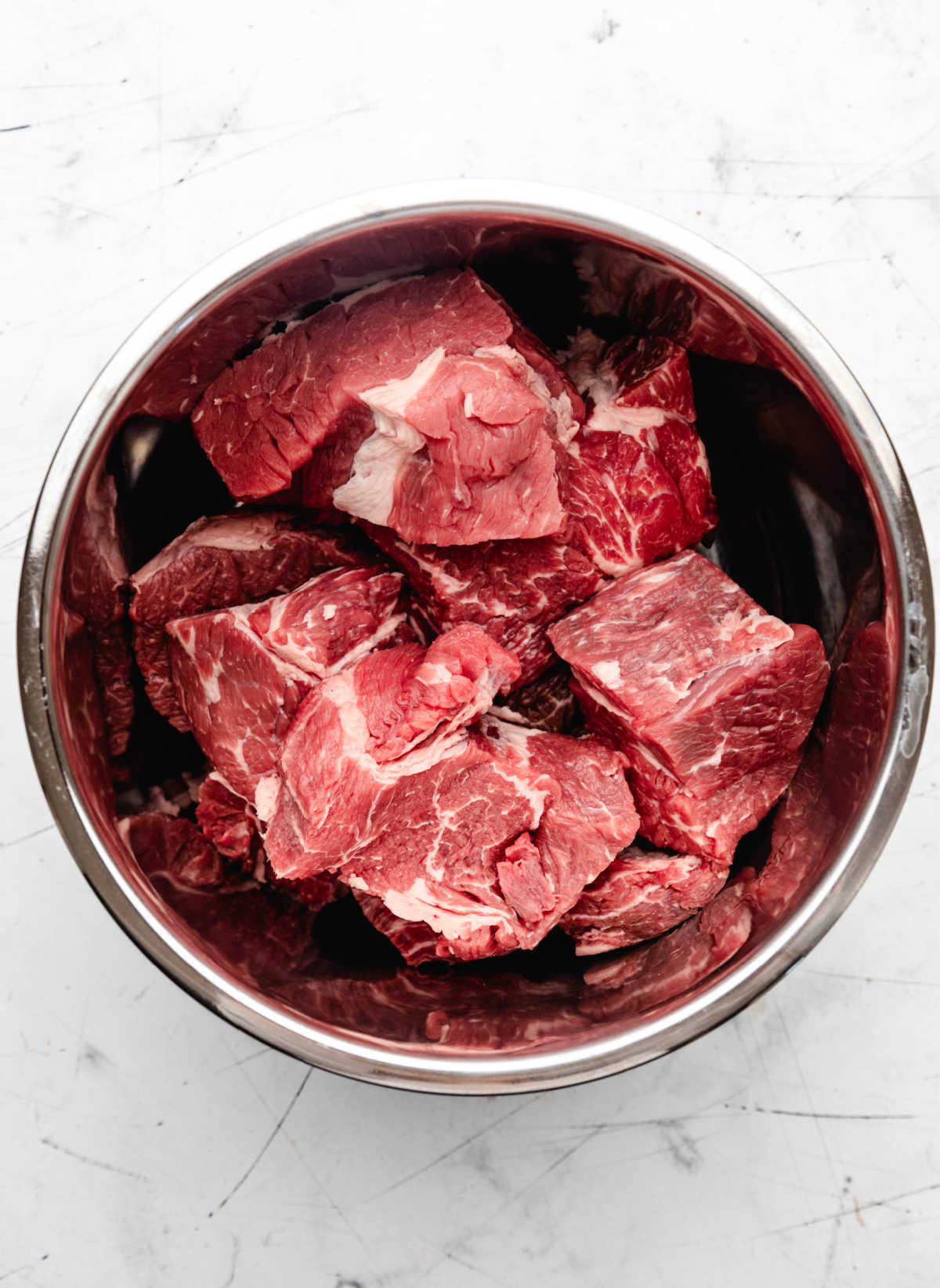 Pieces of chuck roast in an instant pot.
