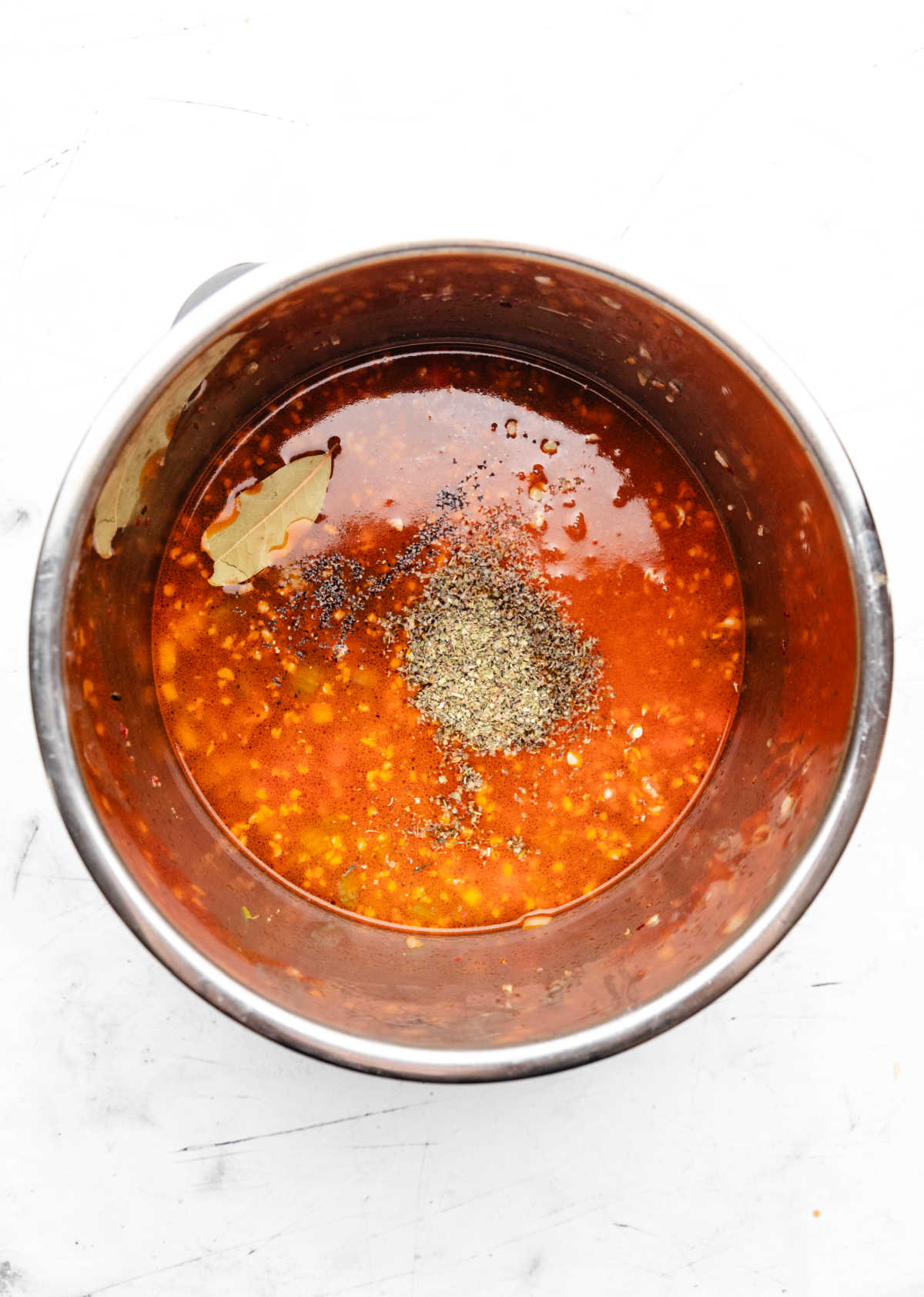 Lentils seasonings and broth mixture in an Instant Pot.