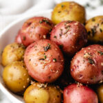 A white dish of Instant Pot herb potatoes.