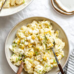 A bowl of Instant Pot potato salad next to a next of potato salad.